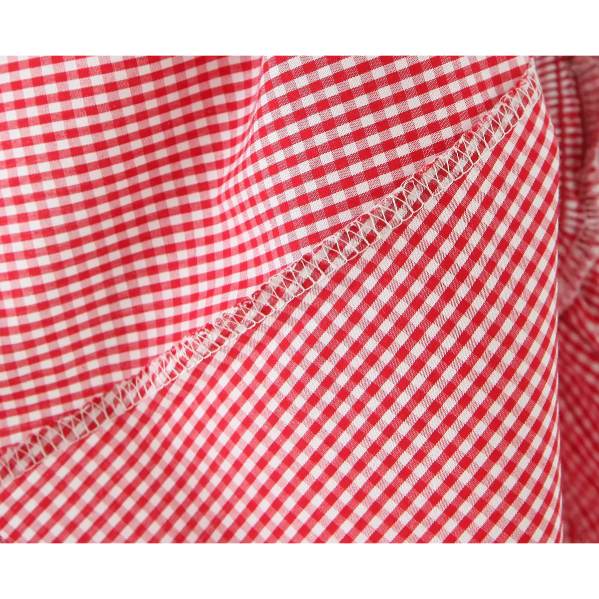 Close of zigzag stitch on red white gingham woven cloth