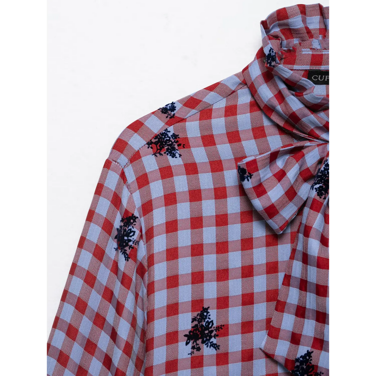 Close-up of shoulder and tie bow detail