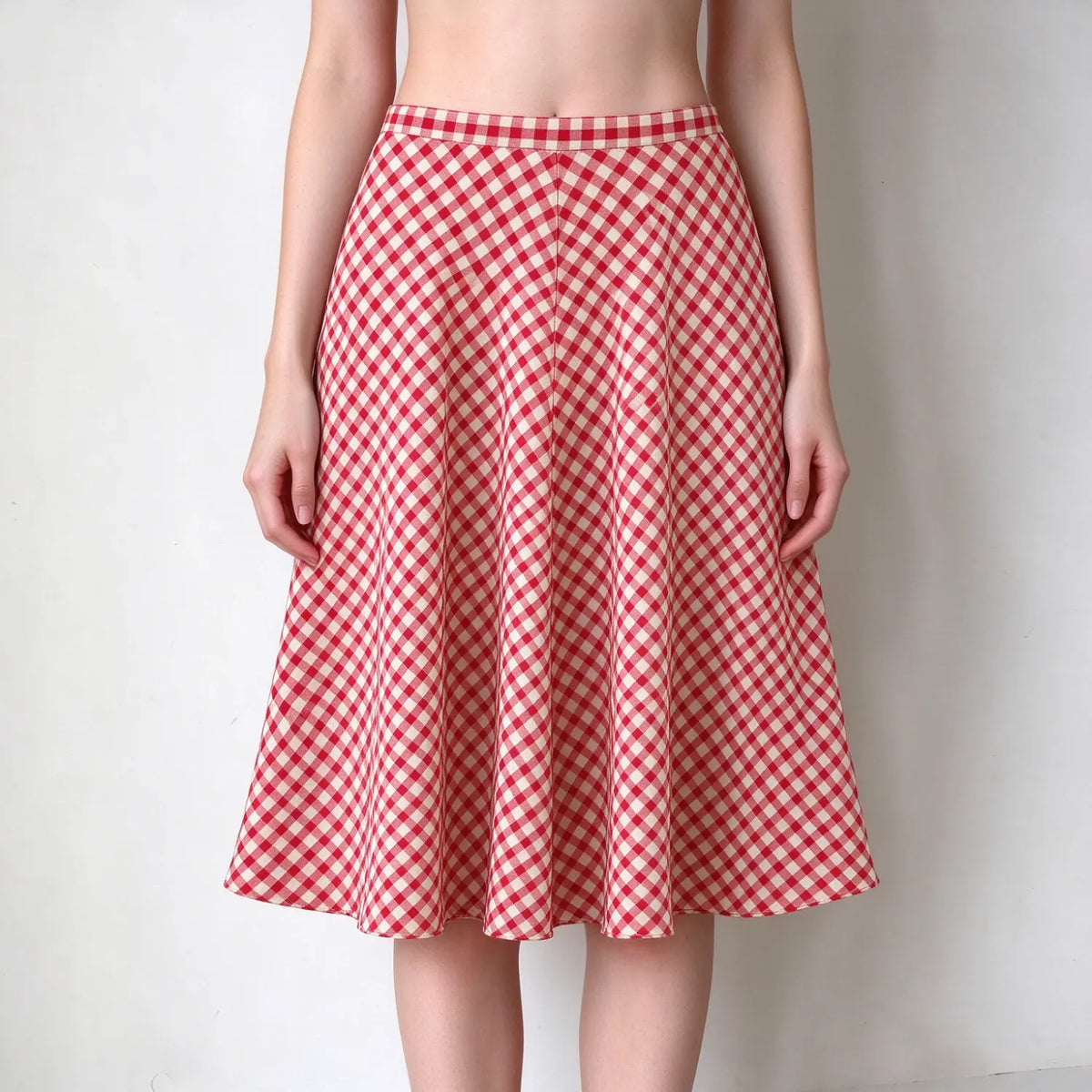 Model wearing gingham high waist flared midi skirt, front view