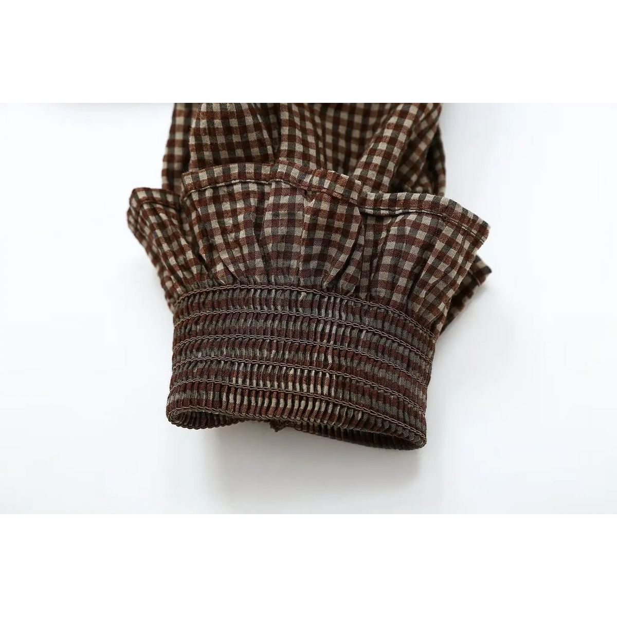 Close-up of smocked cuff and ruffled edge