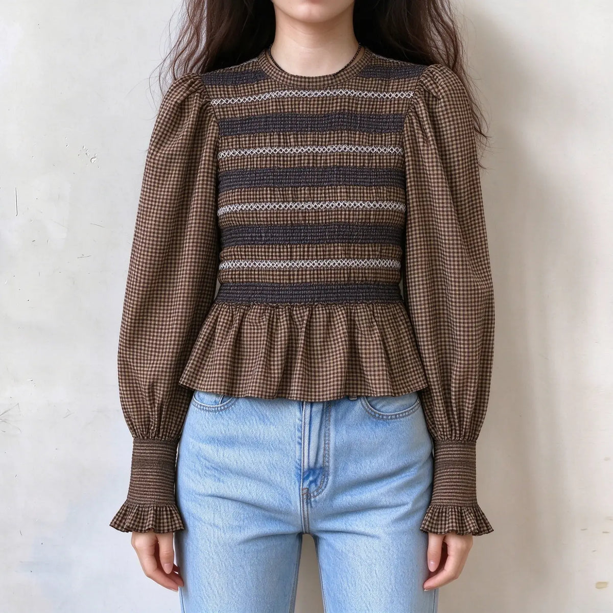 Model wearing gingham smocked ruffle long sleeve blouse with jeans, front view