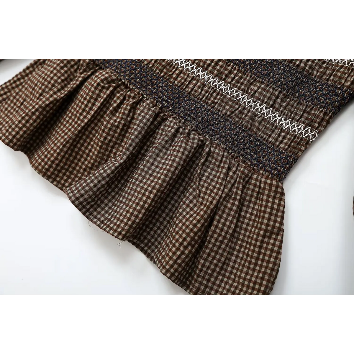 Close-up of peplum hem and smocked waist