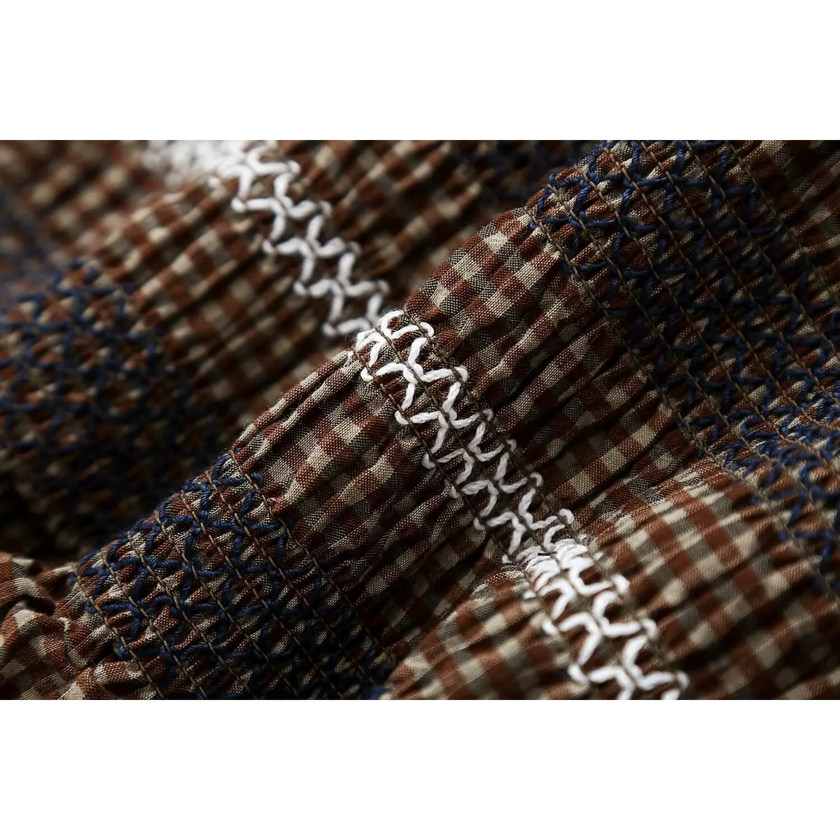 Close-up of white X stitch embroidery texture