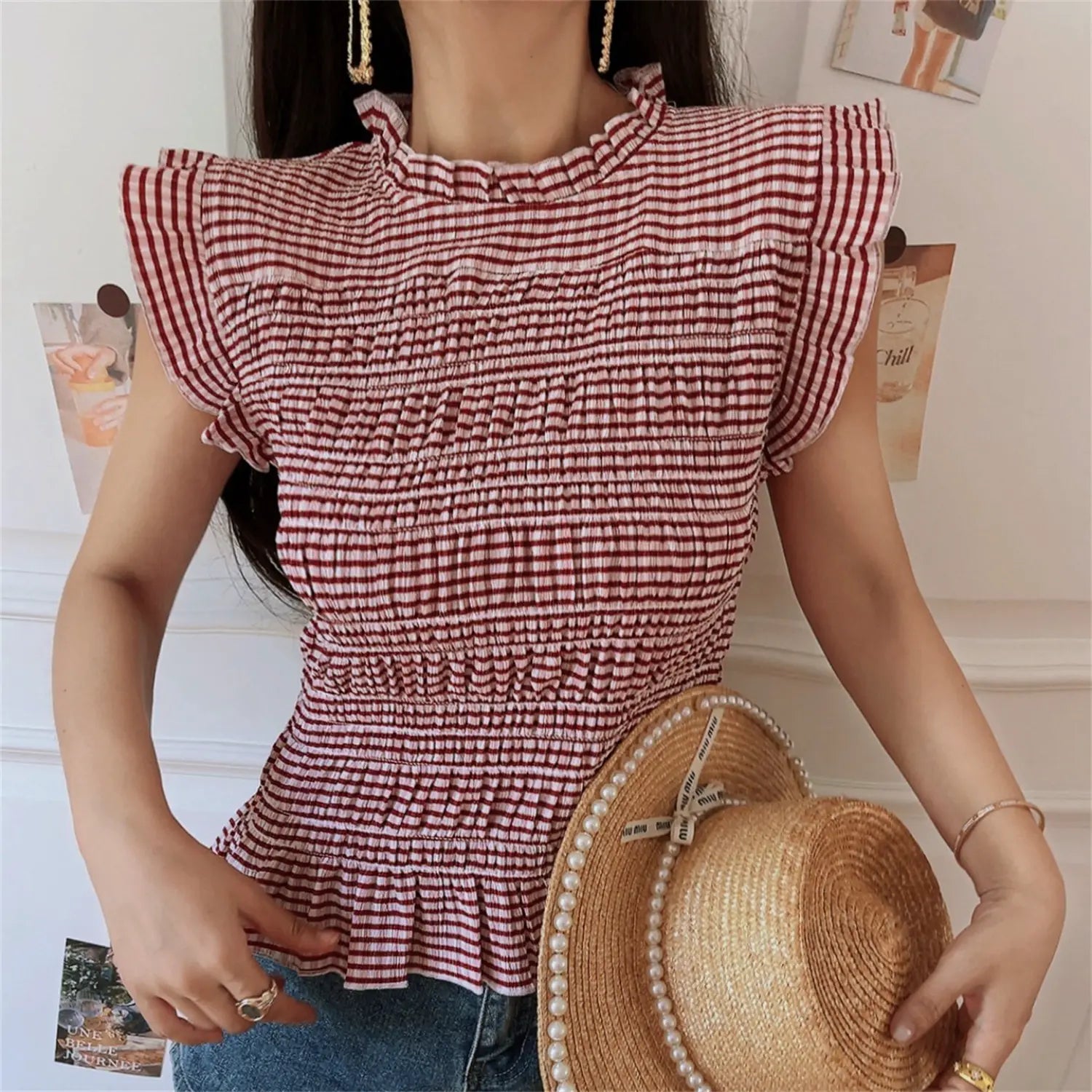 Lifestyle model shot wine red gingham smocked sleeveless top, ruffle stand collar, flutter cap sleeve, full horizontal elastic shirring, peplum hem, slim waist cropped fit, match blue denim shorts