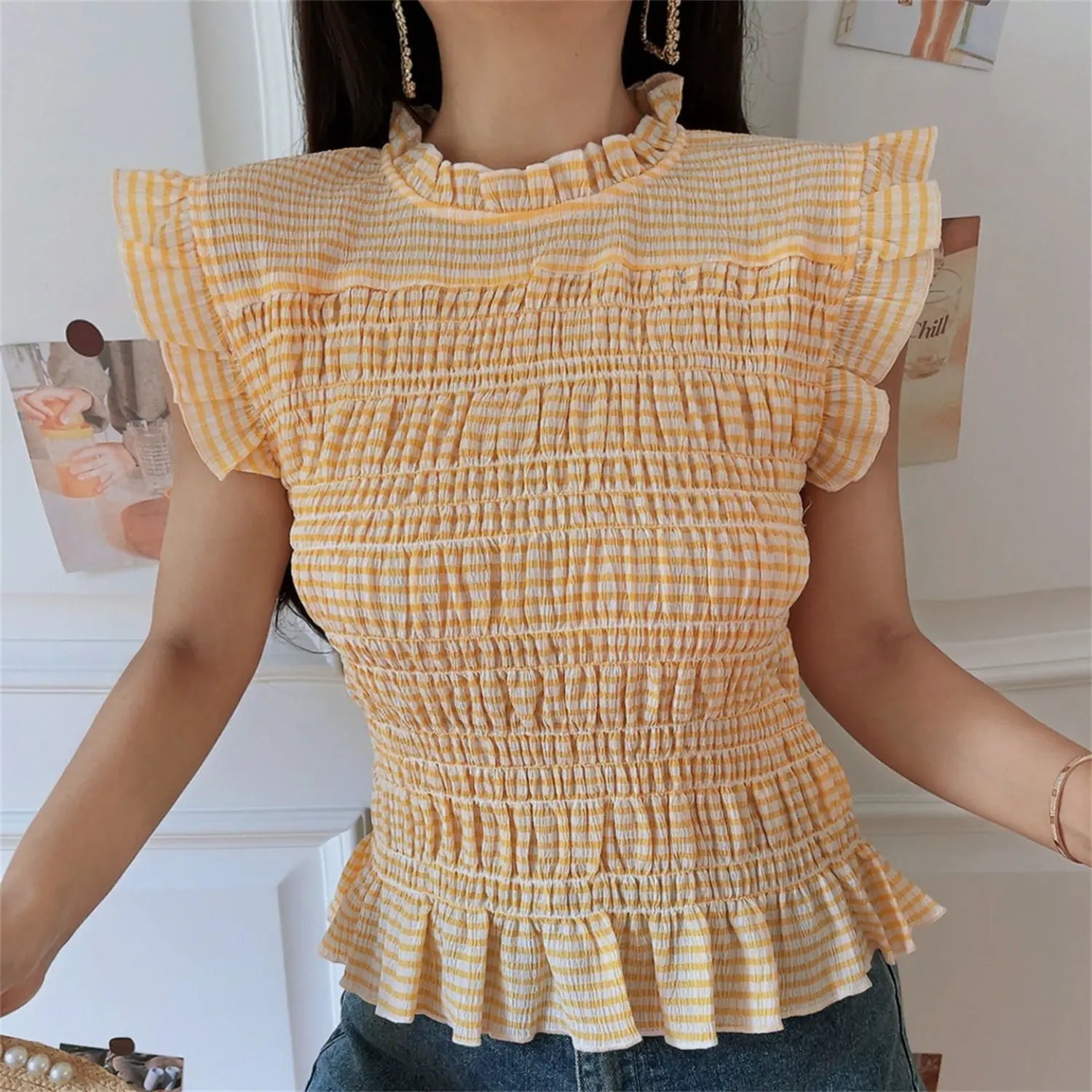 Front full model shot yellow gingham stretch smocked top, frilled high neck, double layer flutter shoulder sleeves, horizontal shirring all over body, ruffle peplum bottom hem