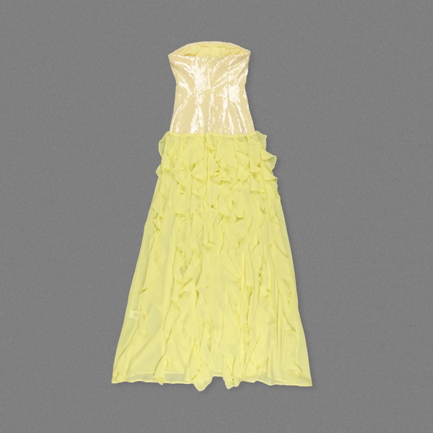 Top-down flat lay shot of yellow sequin strapless maxi evening dress, dense tiered chiffon ruffle skirt, slim fitted corset upper bodice