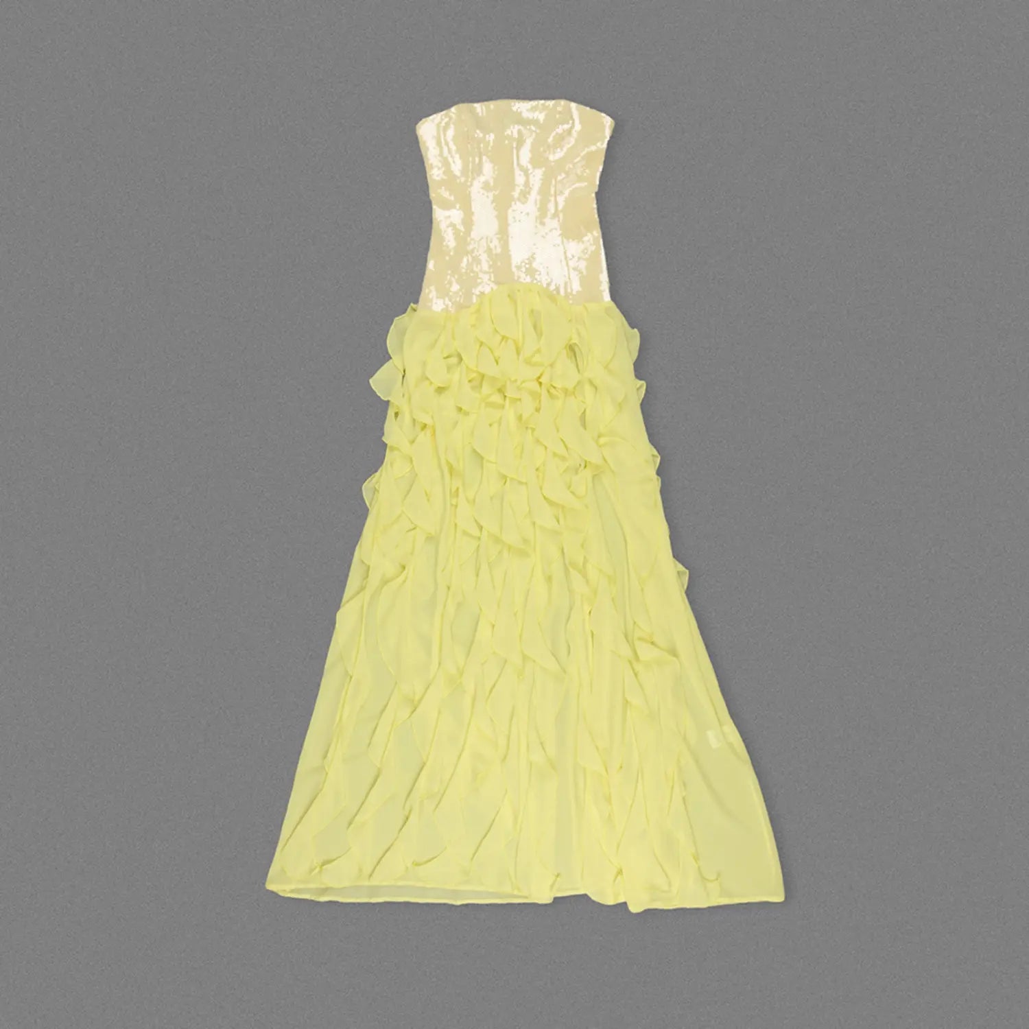 Top-down flat lay back shot of yellow formal strapless maxi dress, shiny sequin bust panel and voluminous layered sheer chiffon ruffle skirt