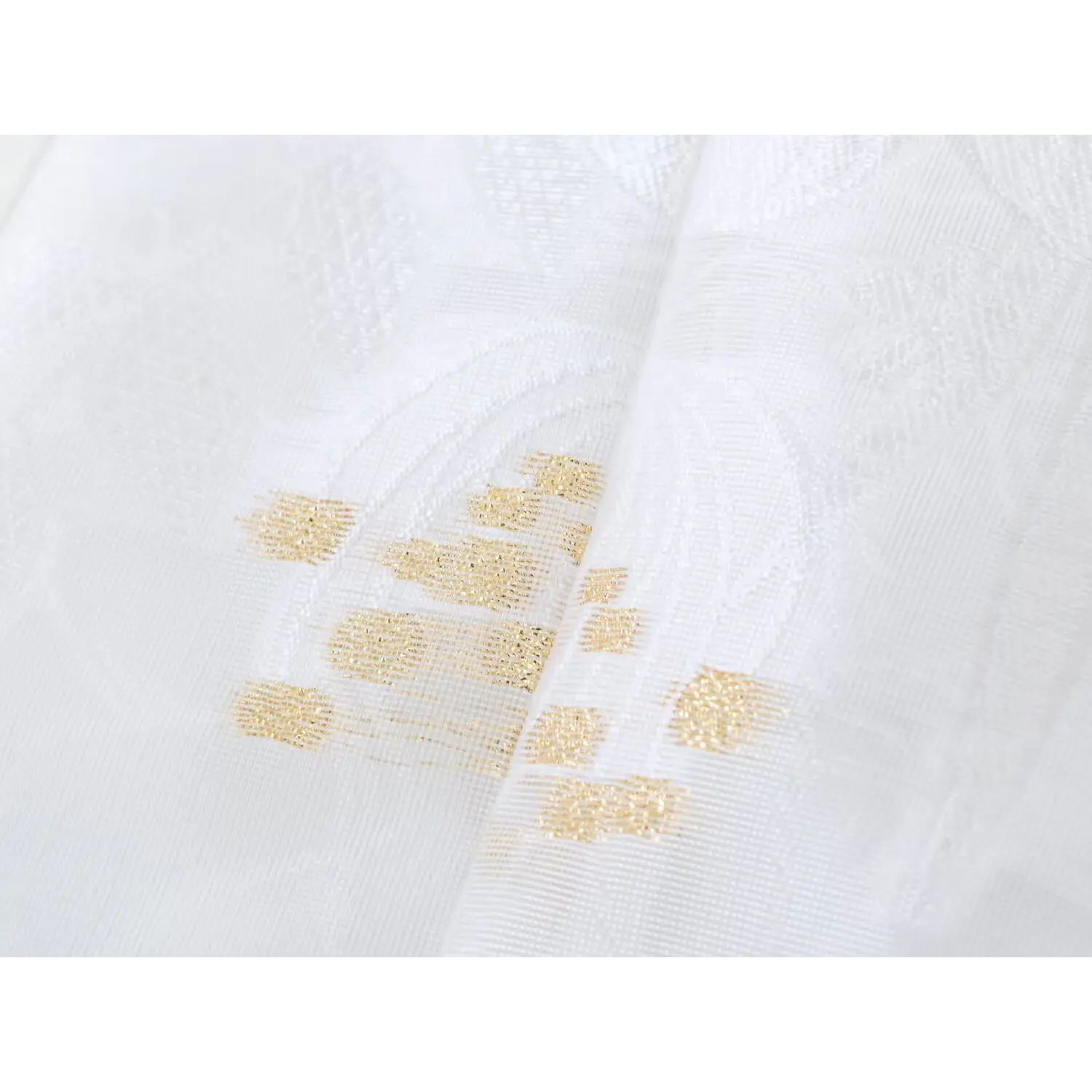 Metallic gold thread flying bird embroidery extreme close-up, textured stitch details on white woven jacquard base