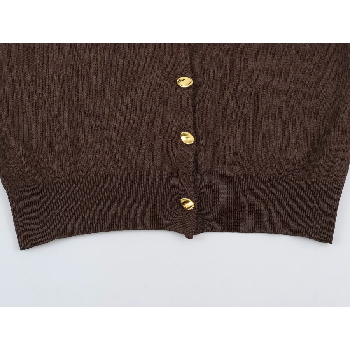 Close-up of brown button placket and hem