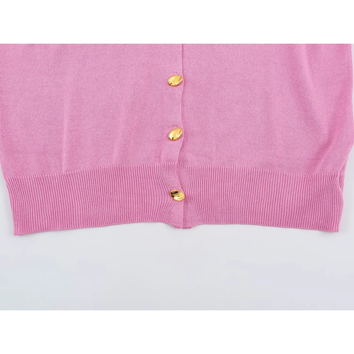 Close-up of pink button placket and hem