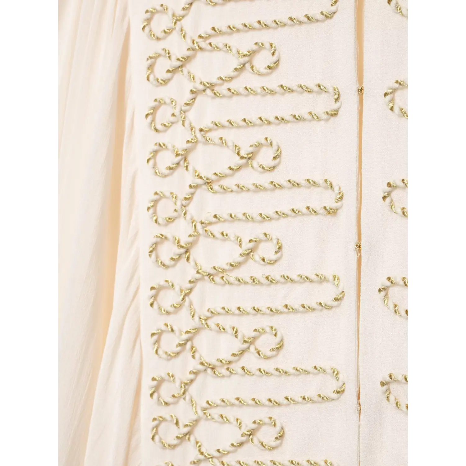Macro shot of intricate gold twisted cord embroidery on front panel of white women blouse