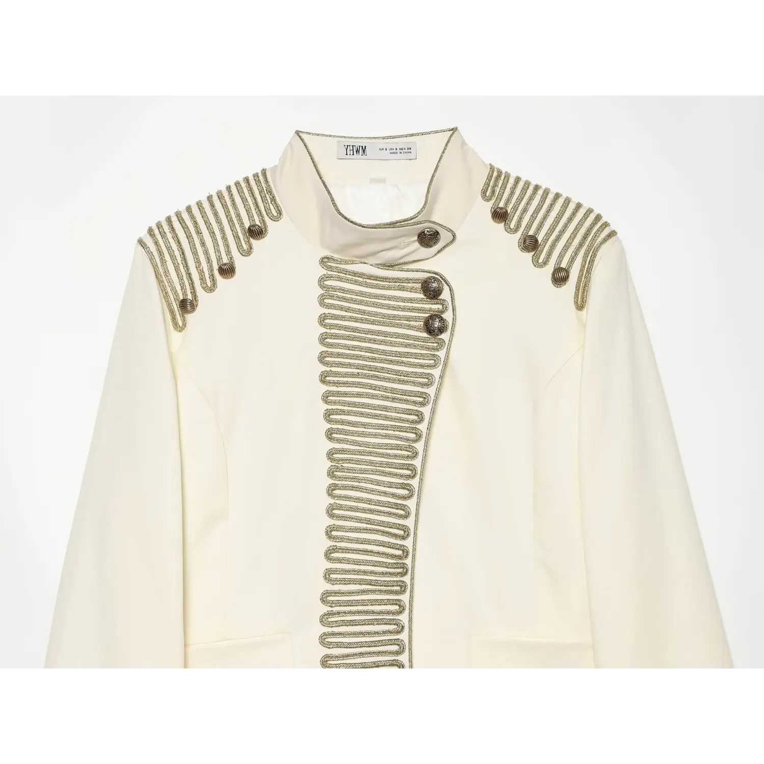 Close-up chest detail of cream stand collar jacket, ornate gold braid piping embroidery and vintage metal buttons