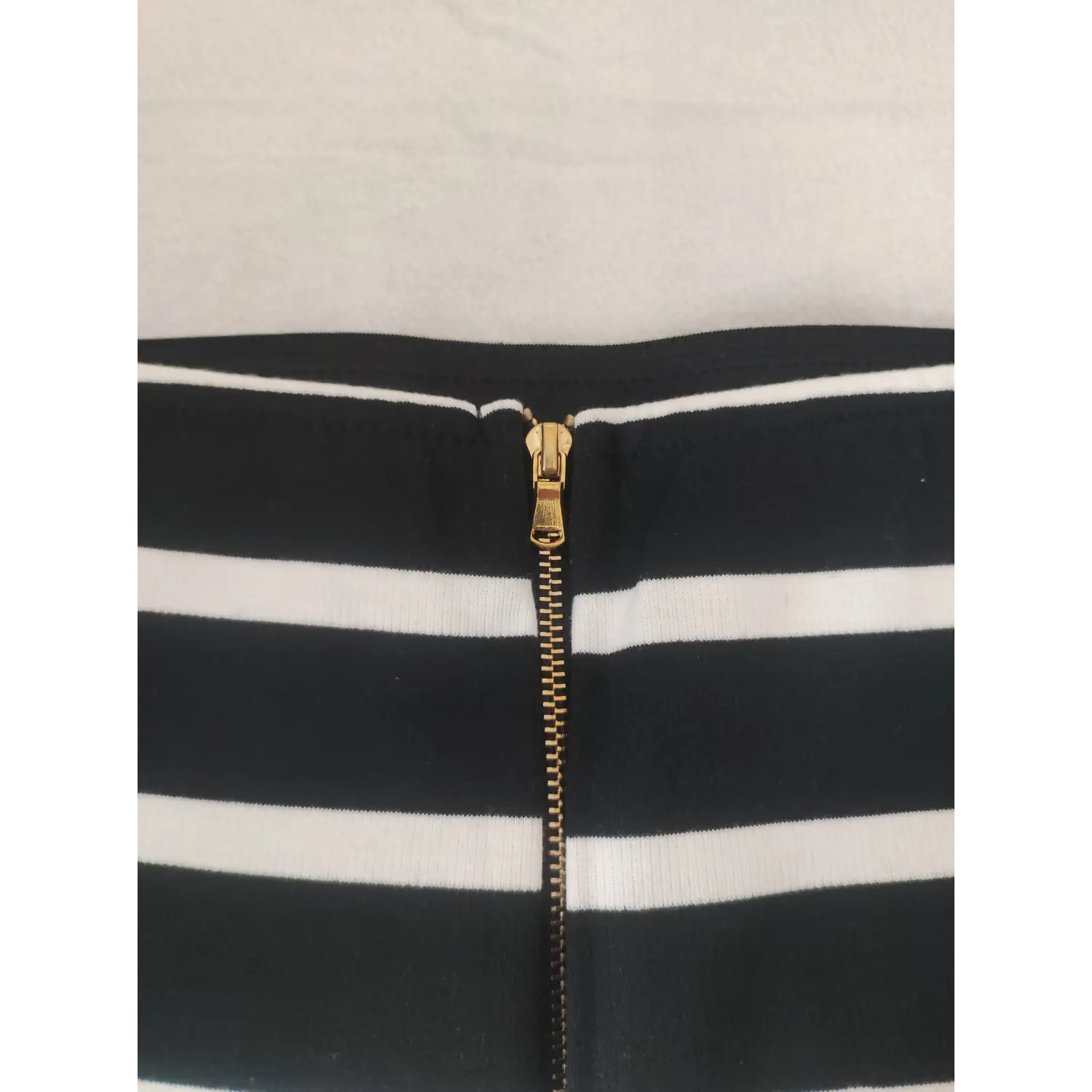 Extreme closeup gold zipper teeth on skirt waistband