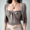 The gray tube top worn alone, highlighting the center bow detail.