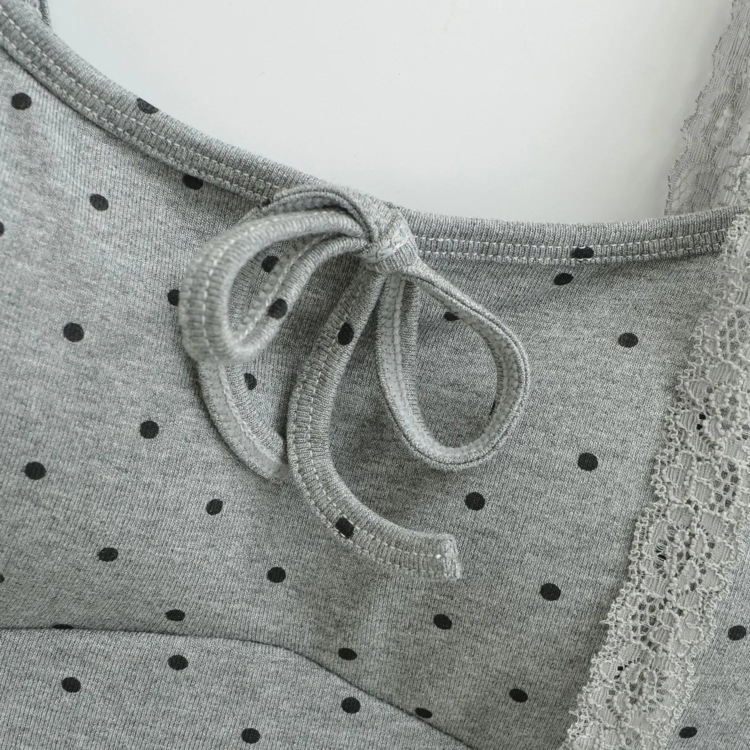 Gray black polka dot knit cami bust bow macro close-up, knit tie bow u-neck edge stitching fabric flat lay detail