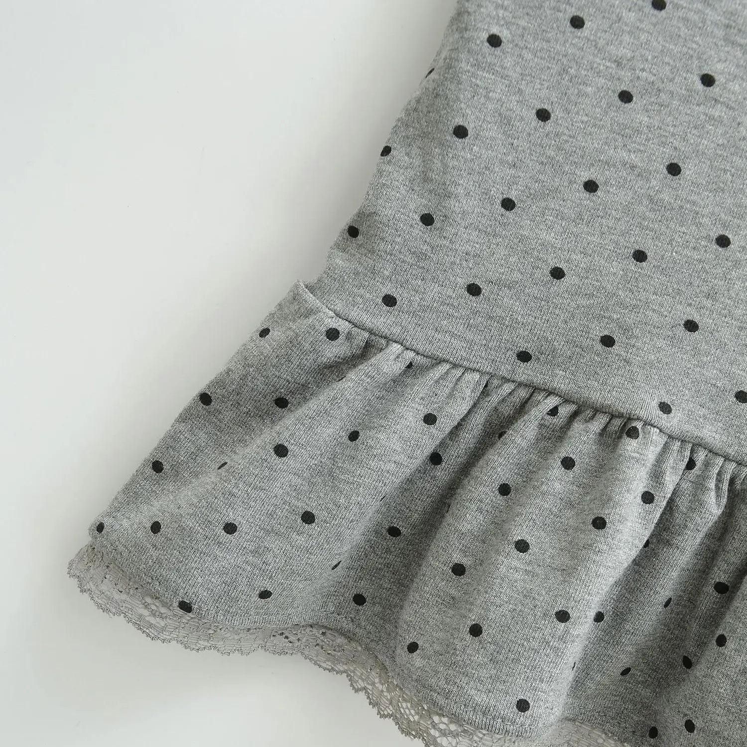 Gray black dot knit cami hem flat detail, peplum ruffle spliced with hollow lace trim stretch knit fabric white background shot