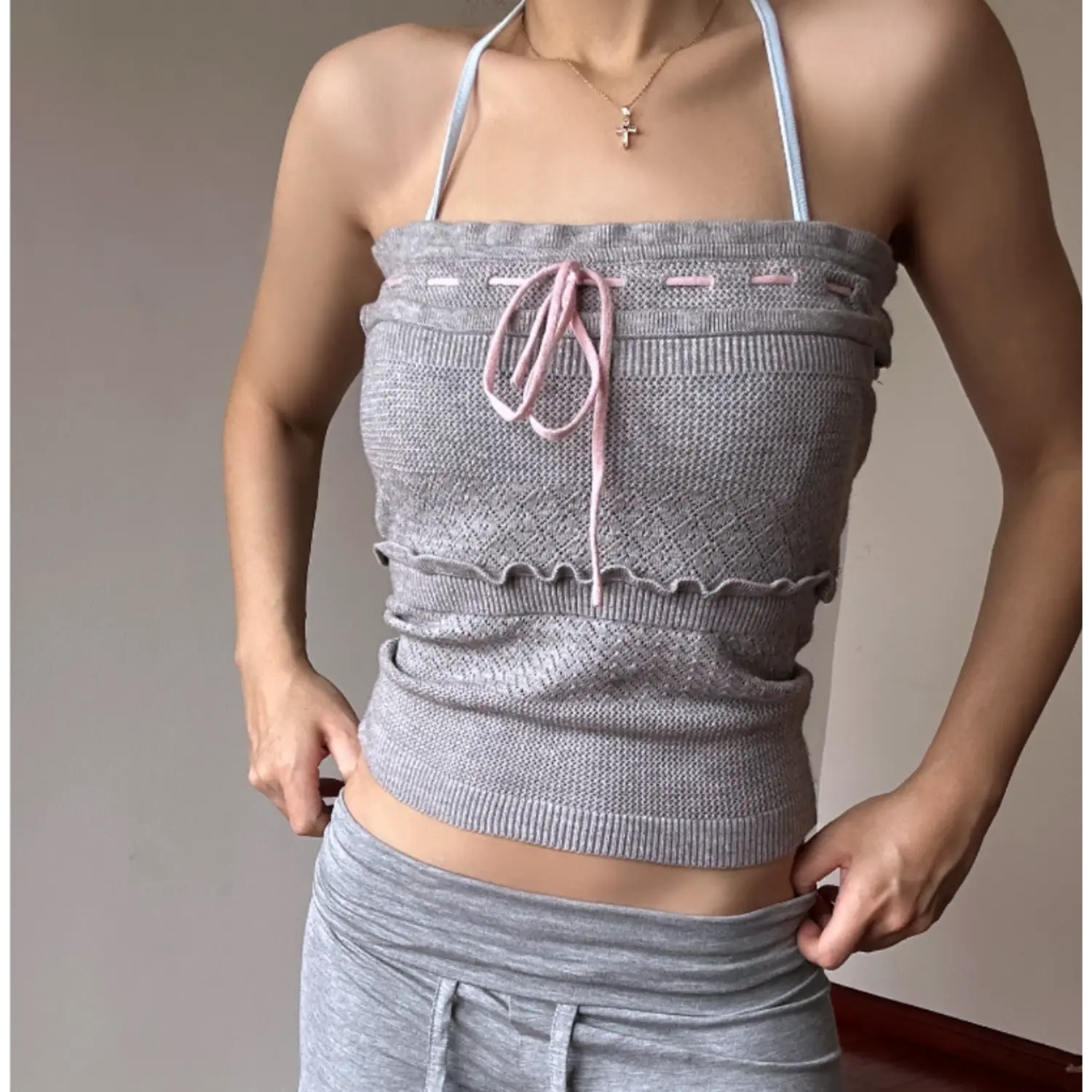 Front view heather grey version worn with matching halter neck straps, textured hollow knit fabric