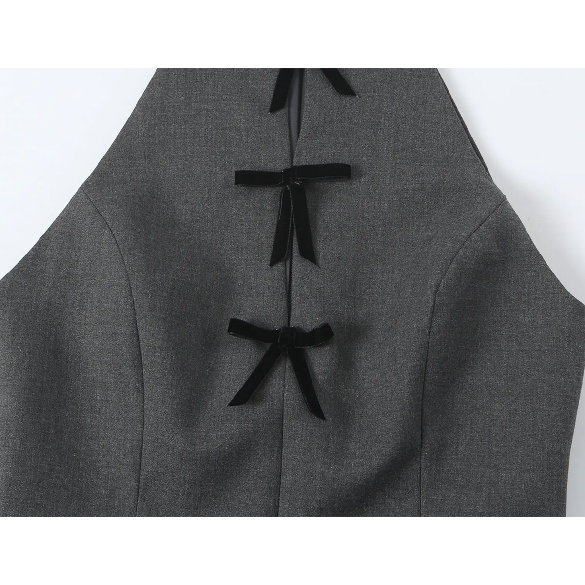 Close-up of front velvet bows and armhole cut-out