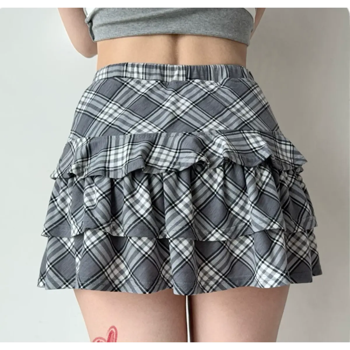 Back view of the gray and white plaid tiered ruffle mini skirt.