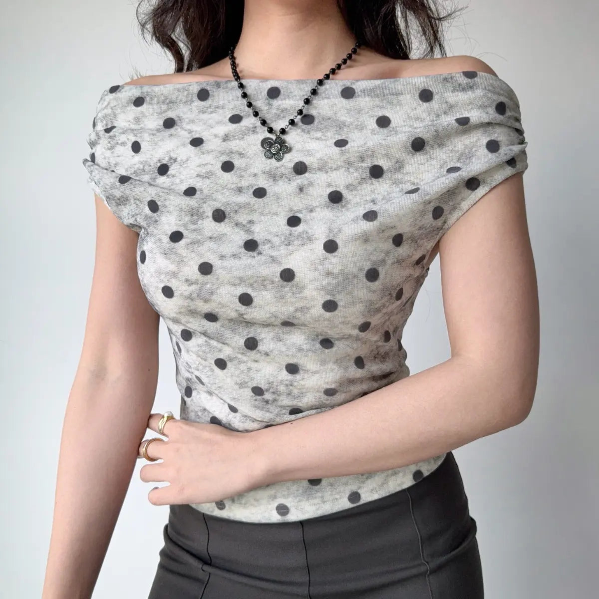 Front view of the same top, showing the draped neckline and fitted silhouette.