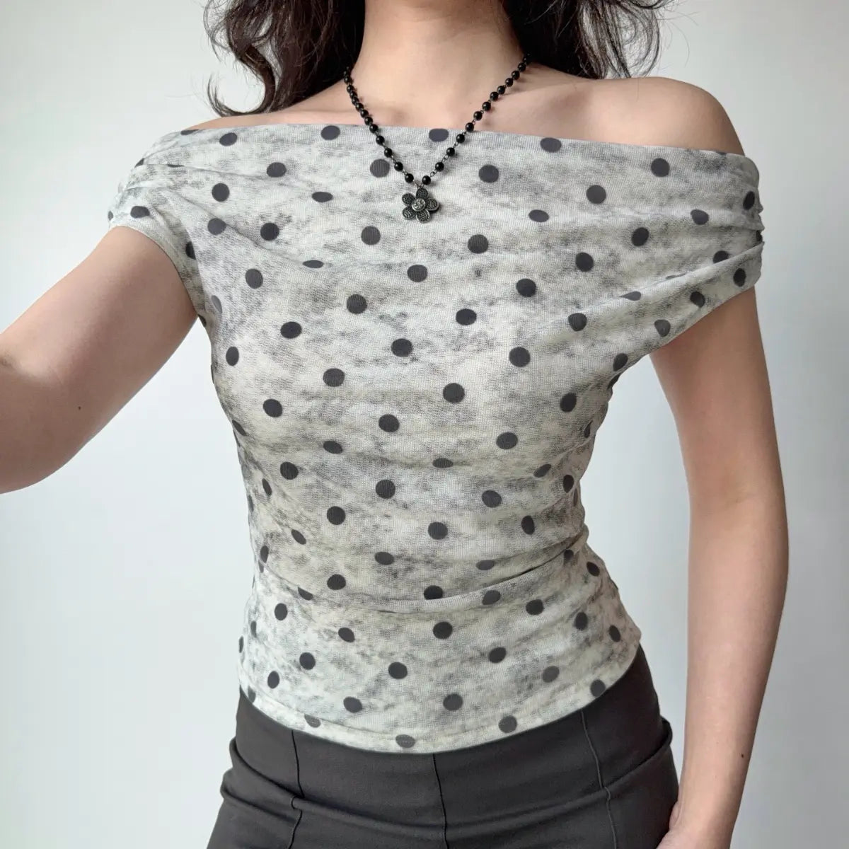 The complete outfit, featuring the polka dot top and gray midi skirt.