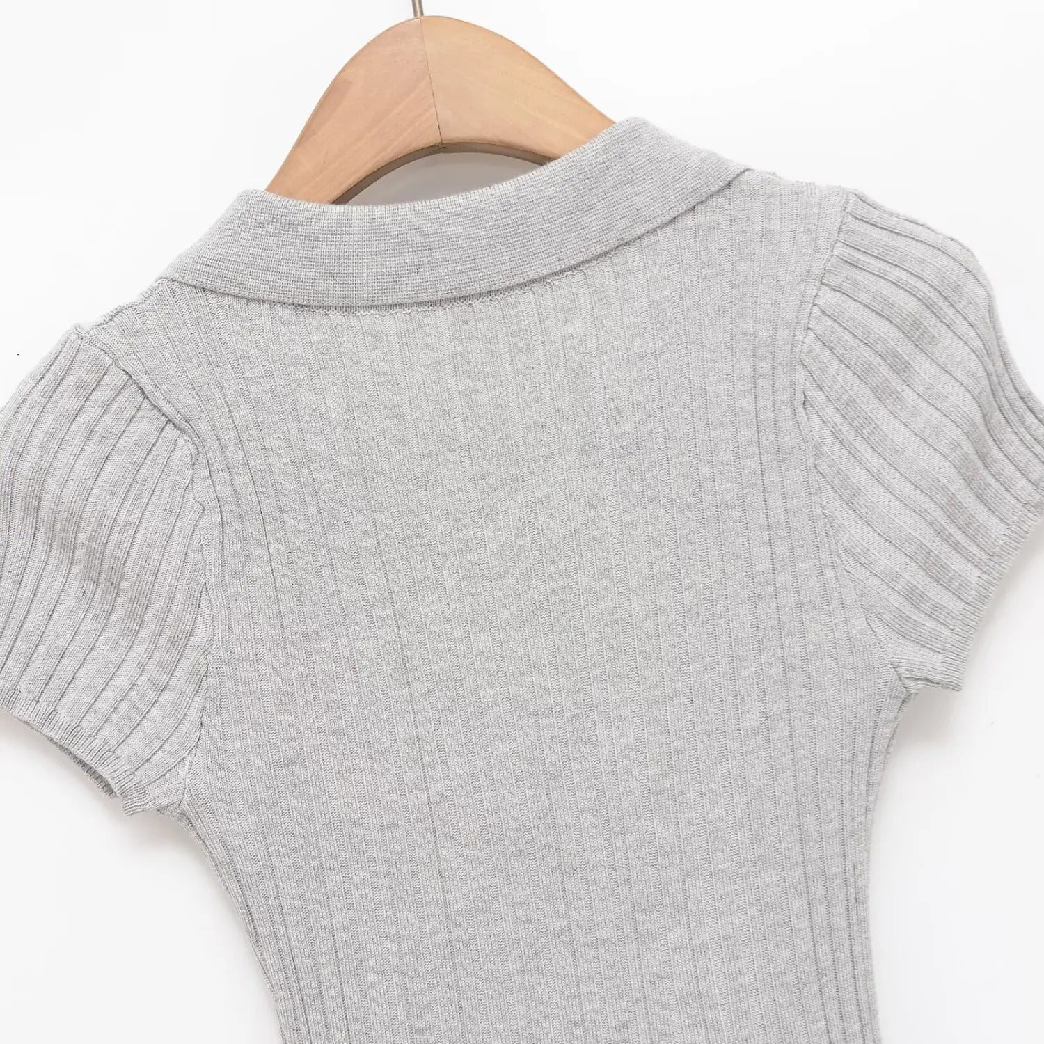 Close-up of the back panel, ribbed texture, and polo collar on the gray knit dress