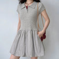  Lifestyle shot of model wearing the gray polo knit dress, showing the form-fitting bodice and puffy skirt