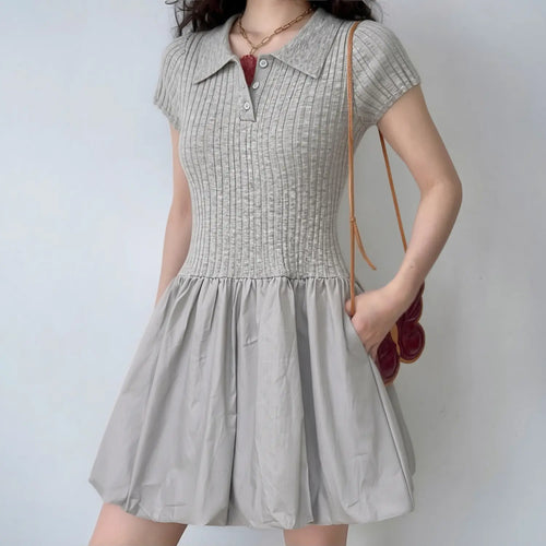 Lifestyle shot of model wearing the gray polo knit dress, showing the form-fitting bodice and puffy skirt