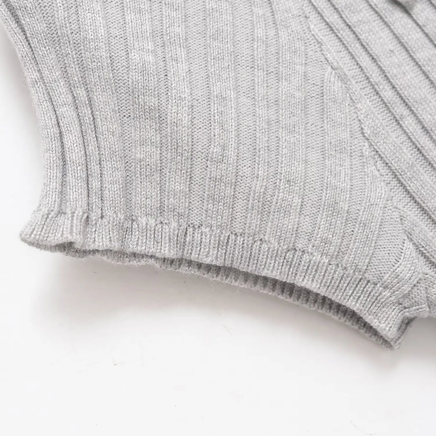 Close-up of the ribbed short sleeve cuff on the gray knit dress