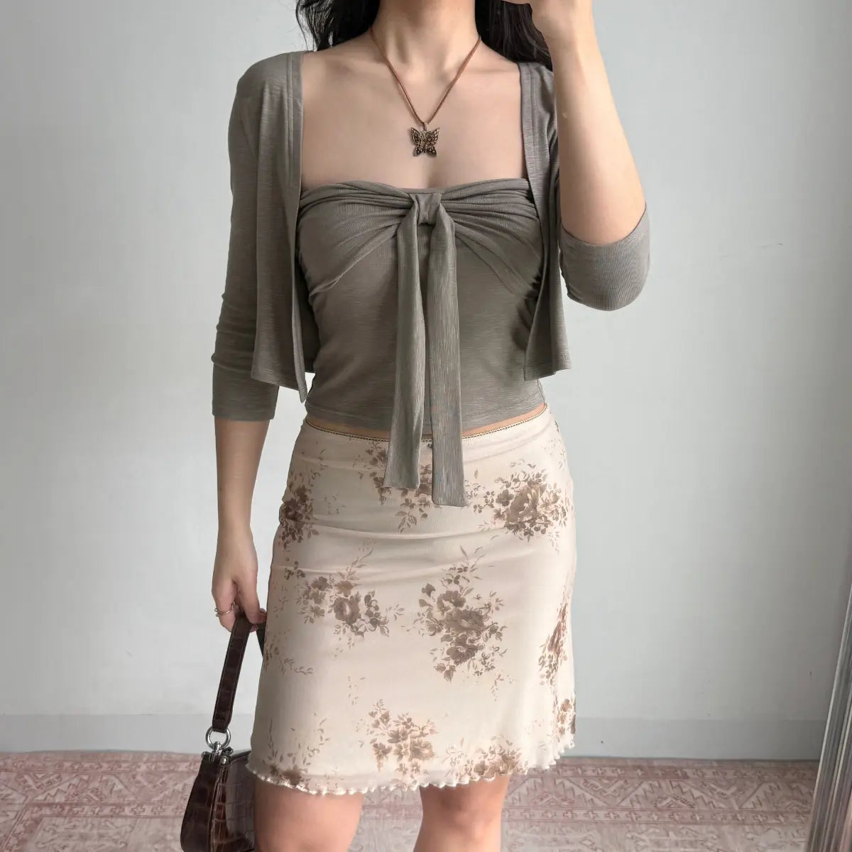 The complete look with gray two-piece set, floral midi skirt, and accessories.