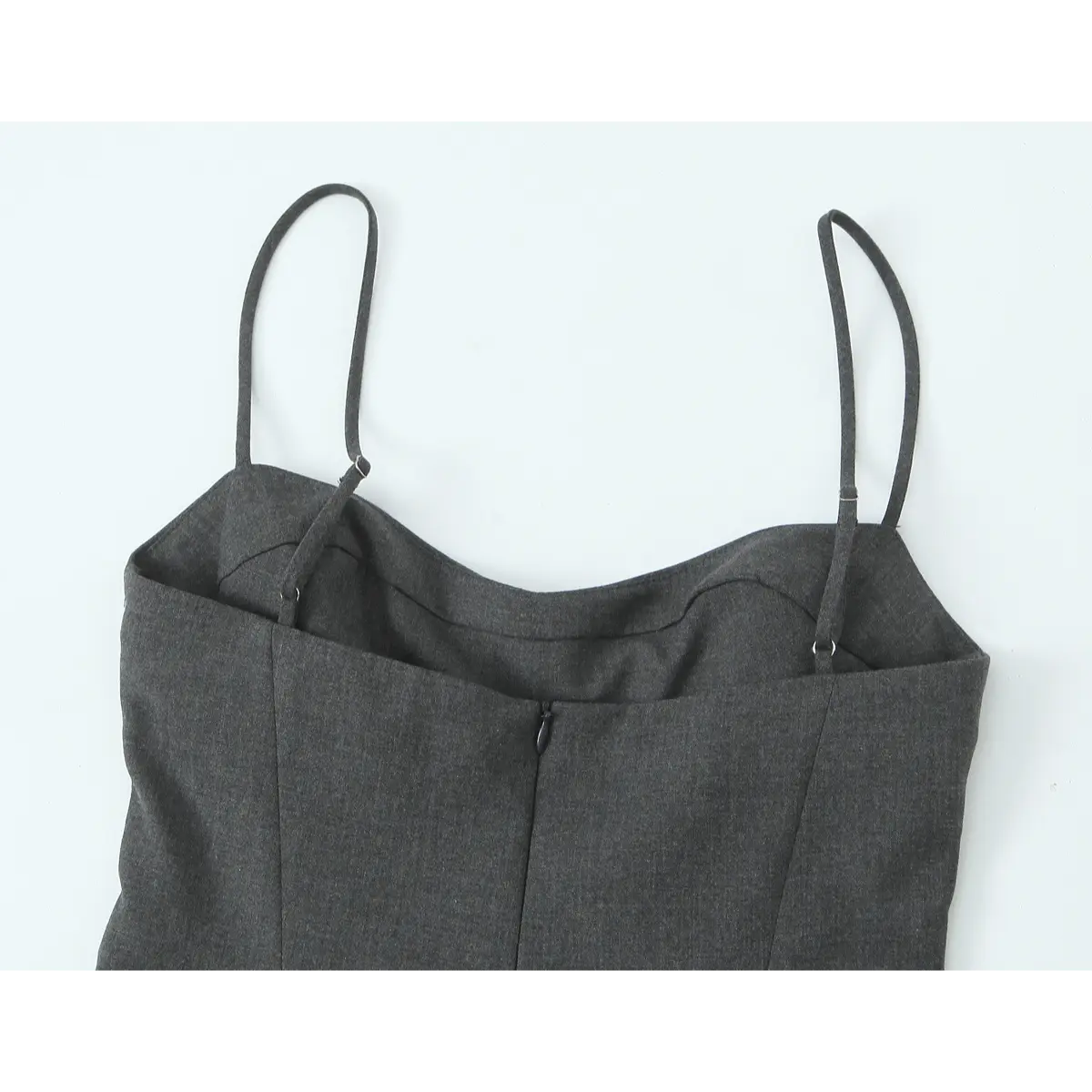 Close-up of the dress's back, showing the adjustable spaghetti straps and the center-back zipper.