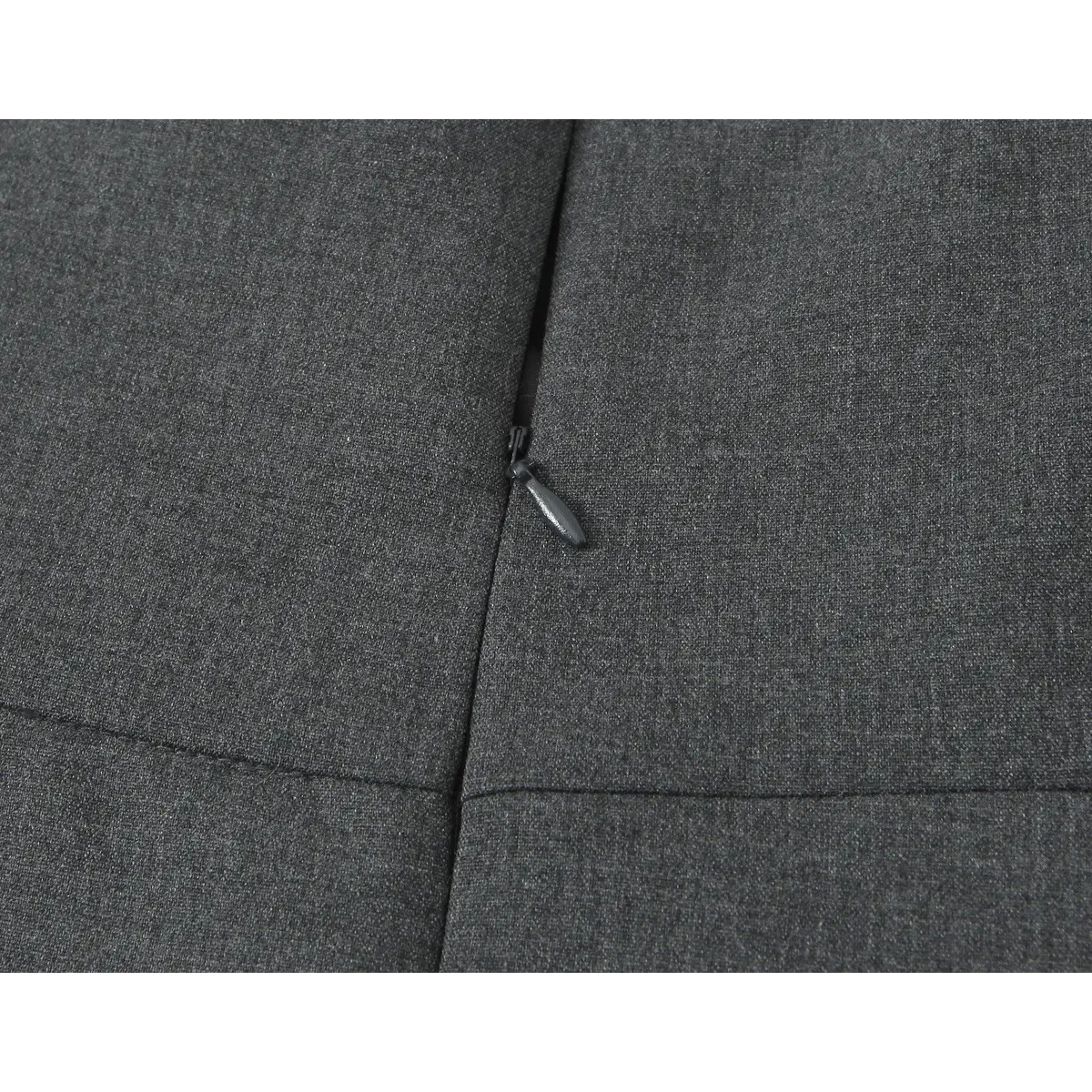 Close-up of the dress's center-back zipper, showing the pull tab and seam construction.