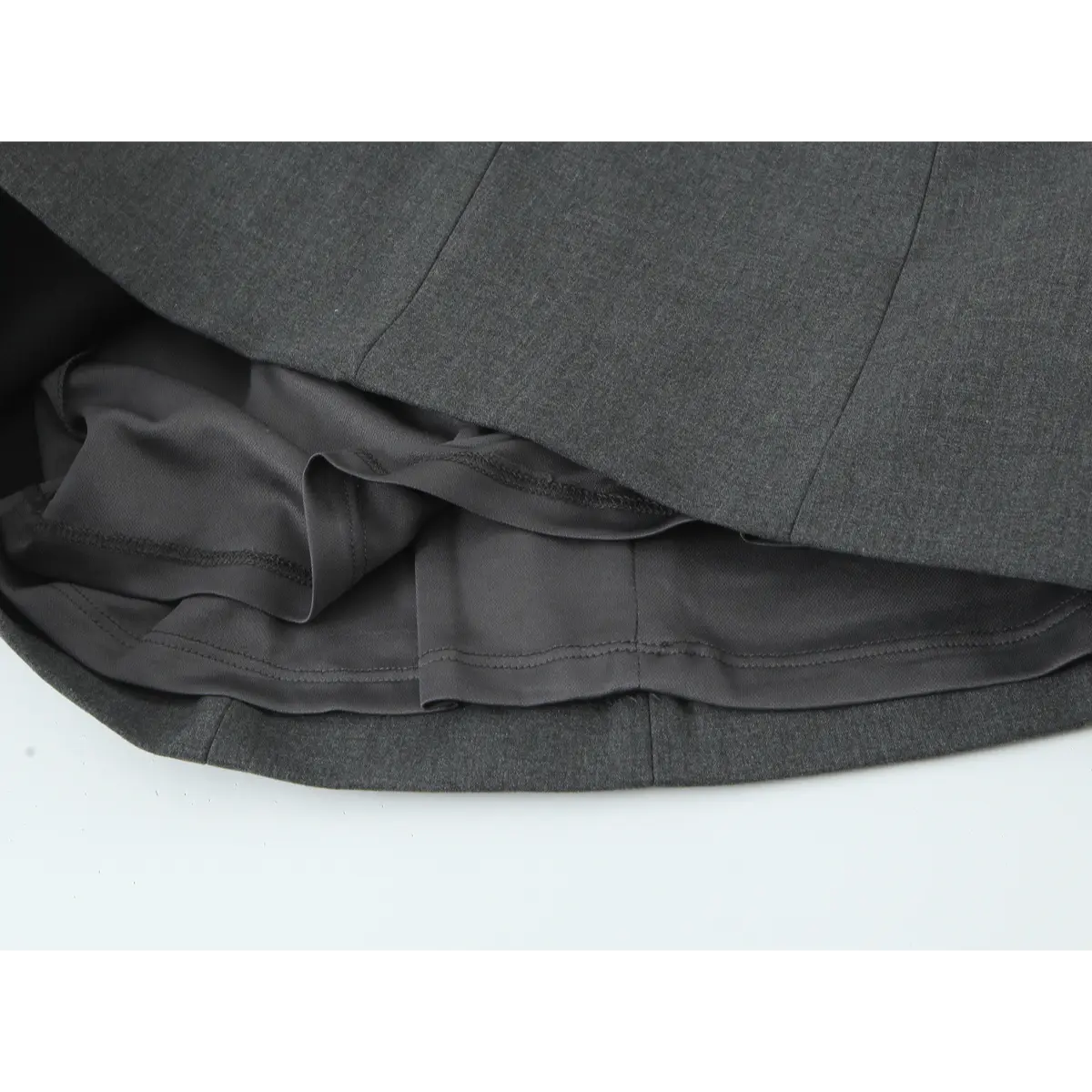  Close-up of the dress's inner lining, showing the construction and the hem of the outer layer.