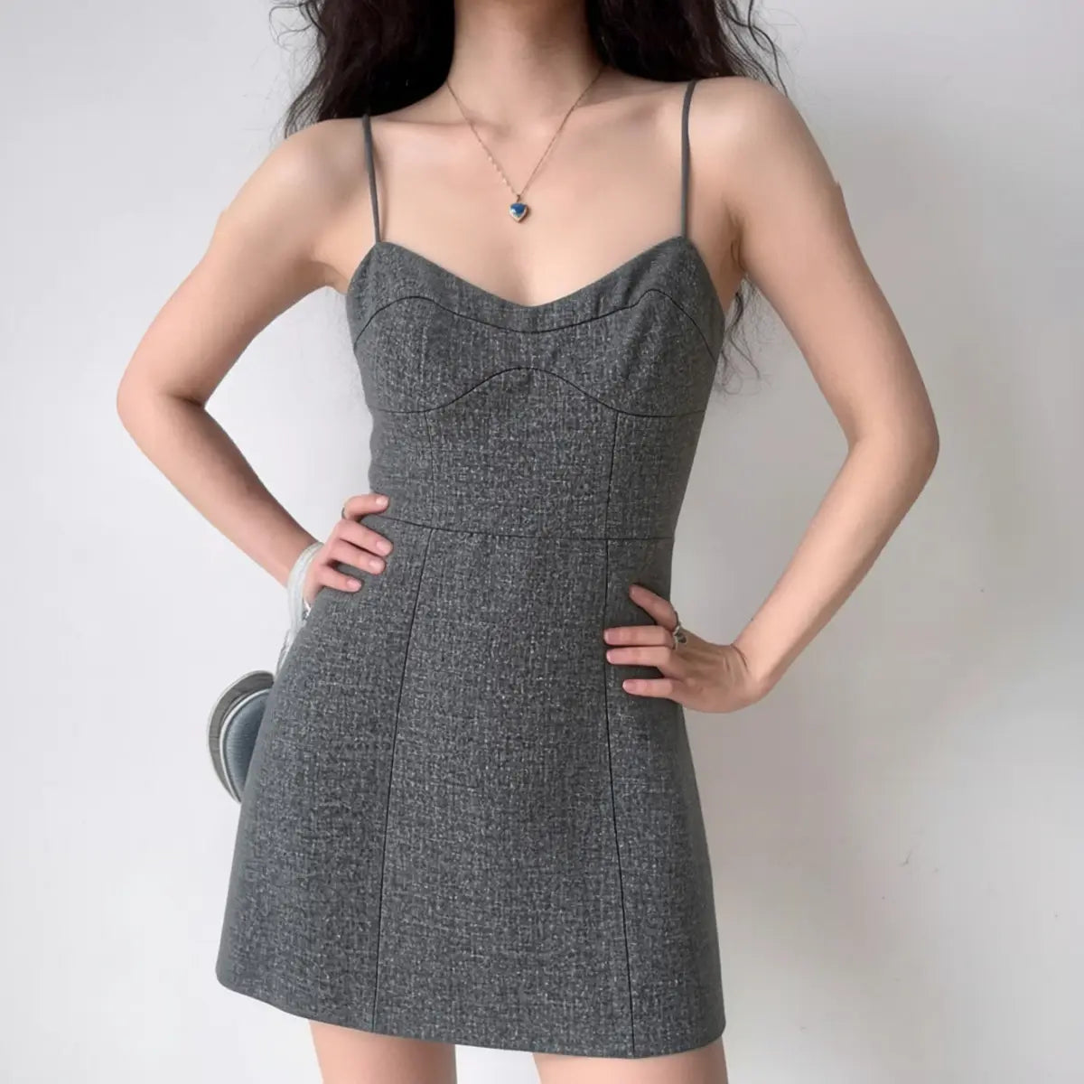 The tailored dress styled on a model, showcasing its polished silhouette and how it elevates a classic look.