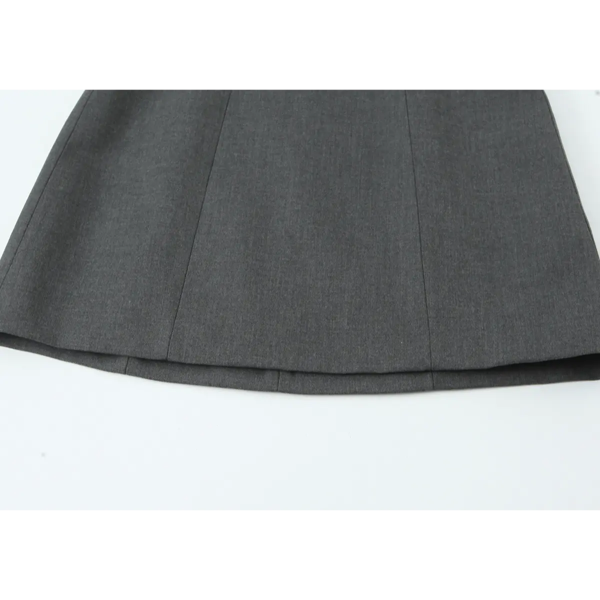 Close-up of the dress's skirt hem, showing the A-line silhouette and vertical panel seams.