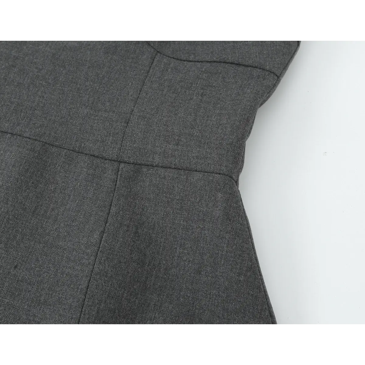 Close-up of the dress's waistline, showing the transition from the fitted bodice to the skirt.