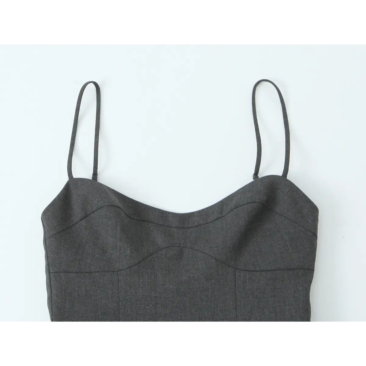 Close-up of the gray top, showing its sweetheart neckline, curved seam detailing, and thin spaghetti straps.