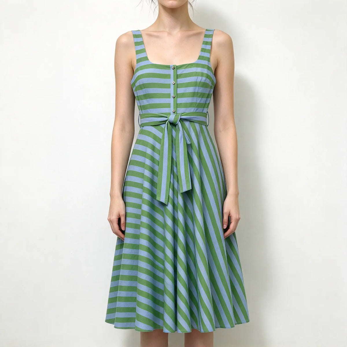 Model wearing green and blue stripe square neck sleeveless maxi dress, front button detail, self tie waist belt, flared long skirt