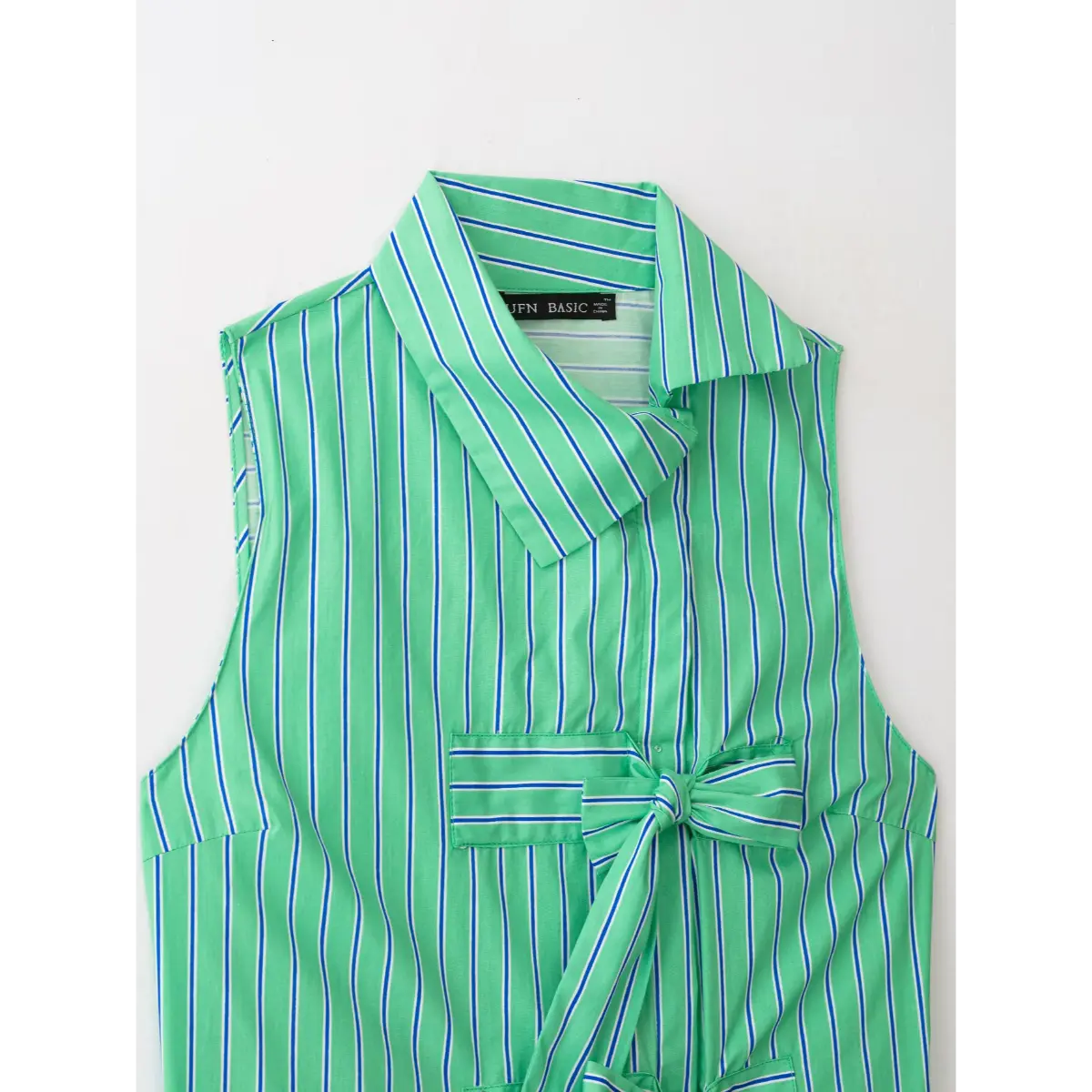 Close of double self-fabric front bow detail on green stripe collared vest top