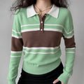 Model wearing cropped polo knit sweater, green brown color‑block stripe, white collar, henley button placket, casual fitted look