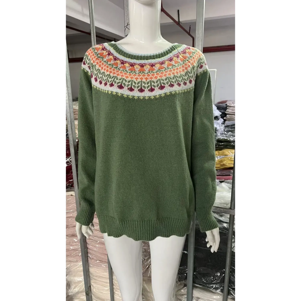 White mannequin display green fairisle jacquard sweater front, round neck yoke multi color floral knit pattern, loose long sleeve sweater