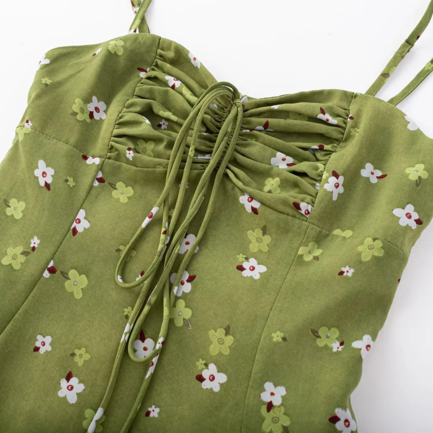 Avocado green floral cami dress bust flat close-up, drawstring gathered tie v-neck chiffon printed fabric stitching white background shot