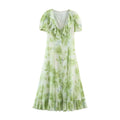 Front view green floral print maxi dress, v‑neck ruffle collar, short puff sleeves, front button placket, ruffle hem, white background