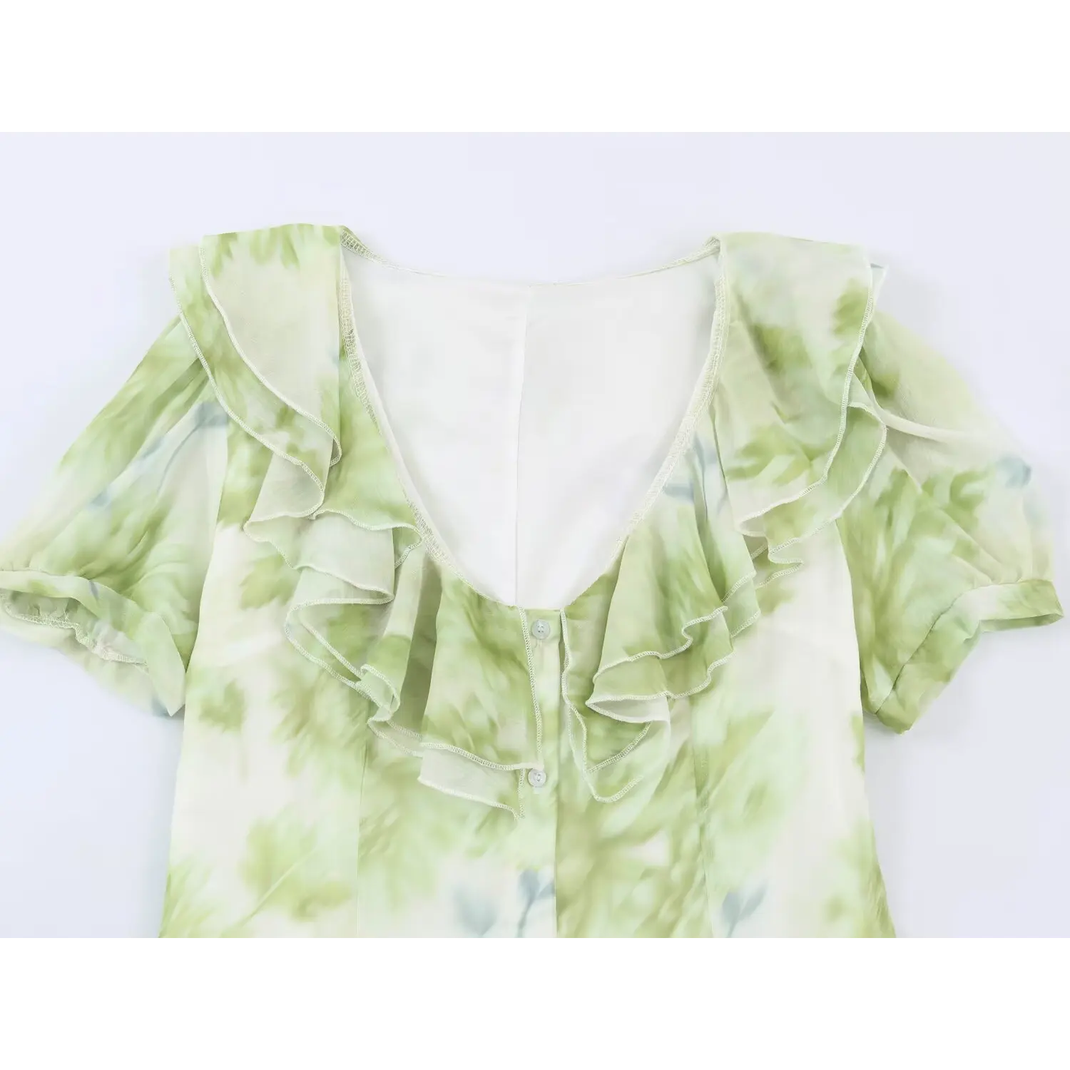 Close‑up of v‑neck layered ruffle collar and short puff sleeve for green floral maxi dress, front button detail