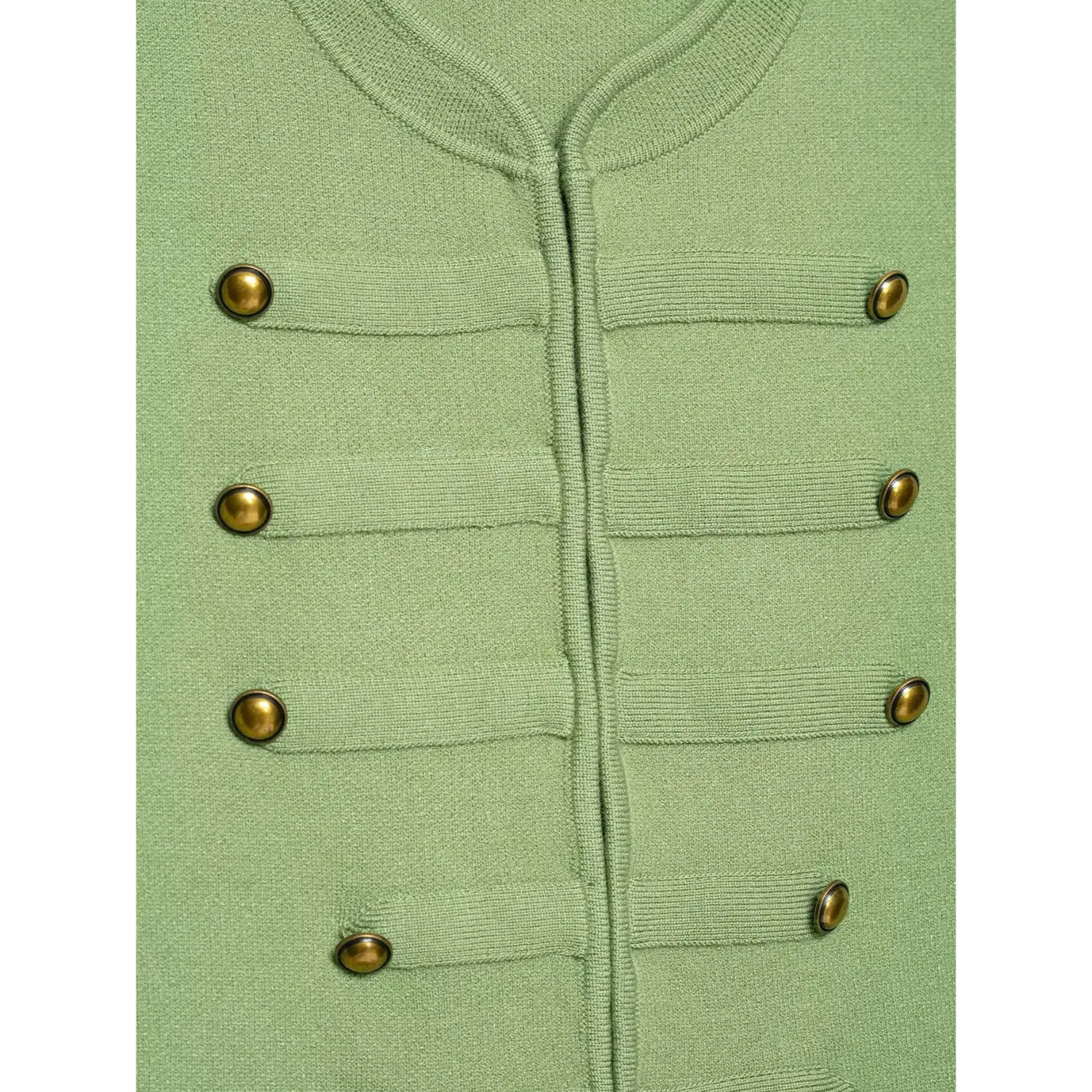 Close‑up view of double breasted antique brass buttons and front placket stitching on green knit waistcoat