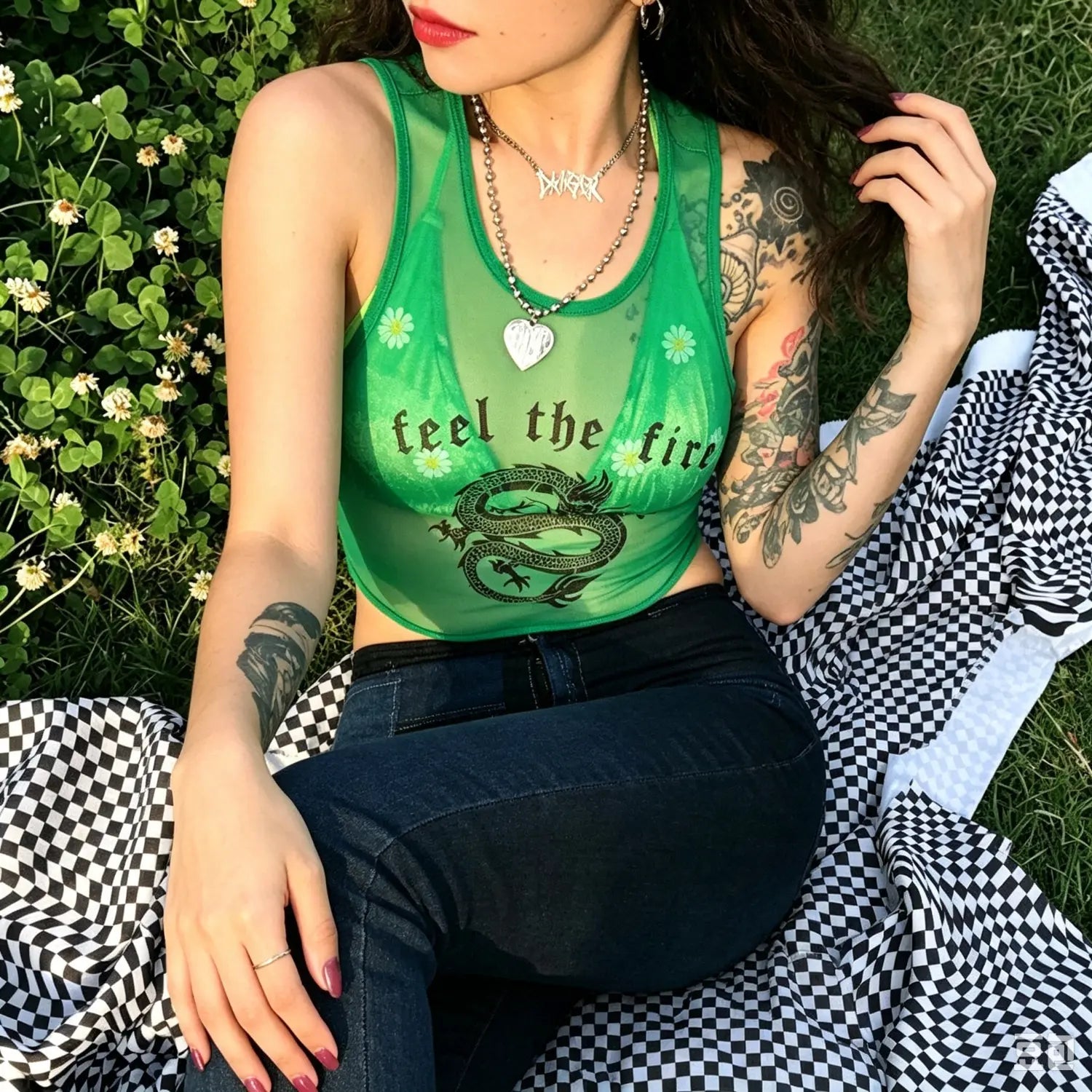 Outdoor grass model shot green sheer mesh crop tank top with dragon graphic and feel the fire text print