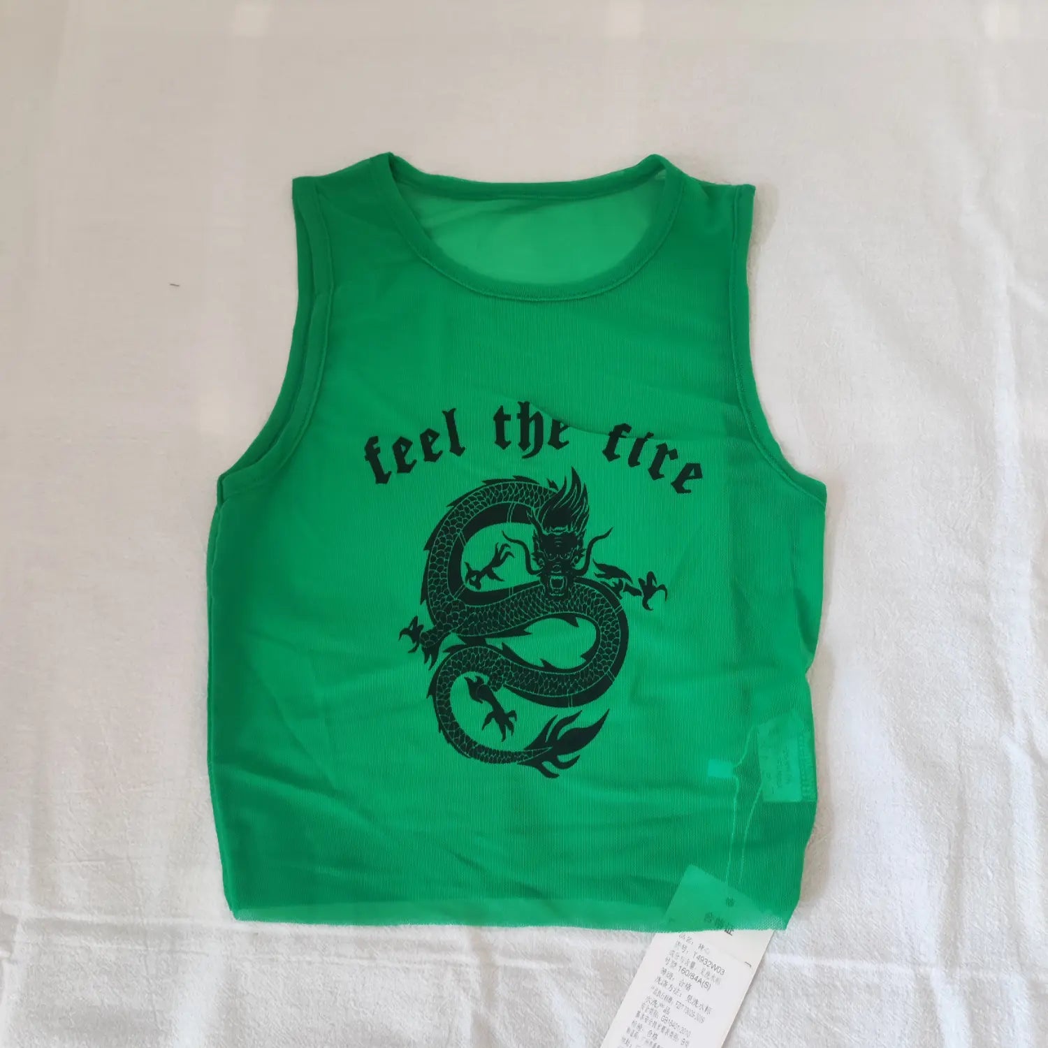 Flat lay front view green sheer mesh sleeveless crop tank top with dragon and feel the fire text graphic