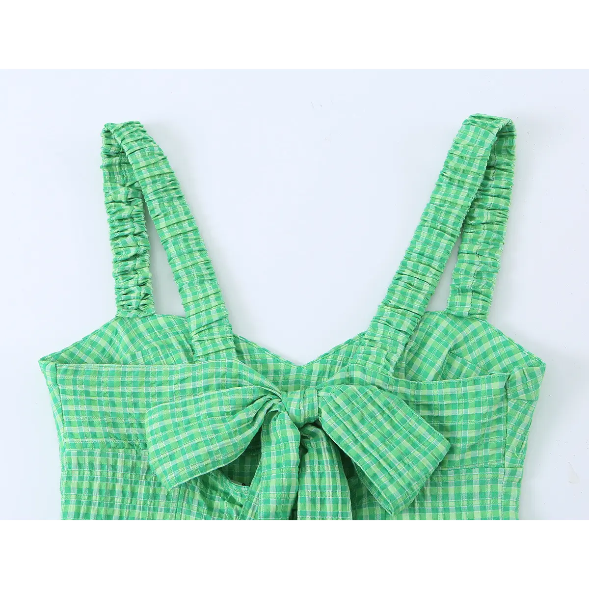 Close-up of the dress's back, highlighting the large matching gingham bow at the waist and smocked straps.