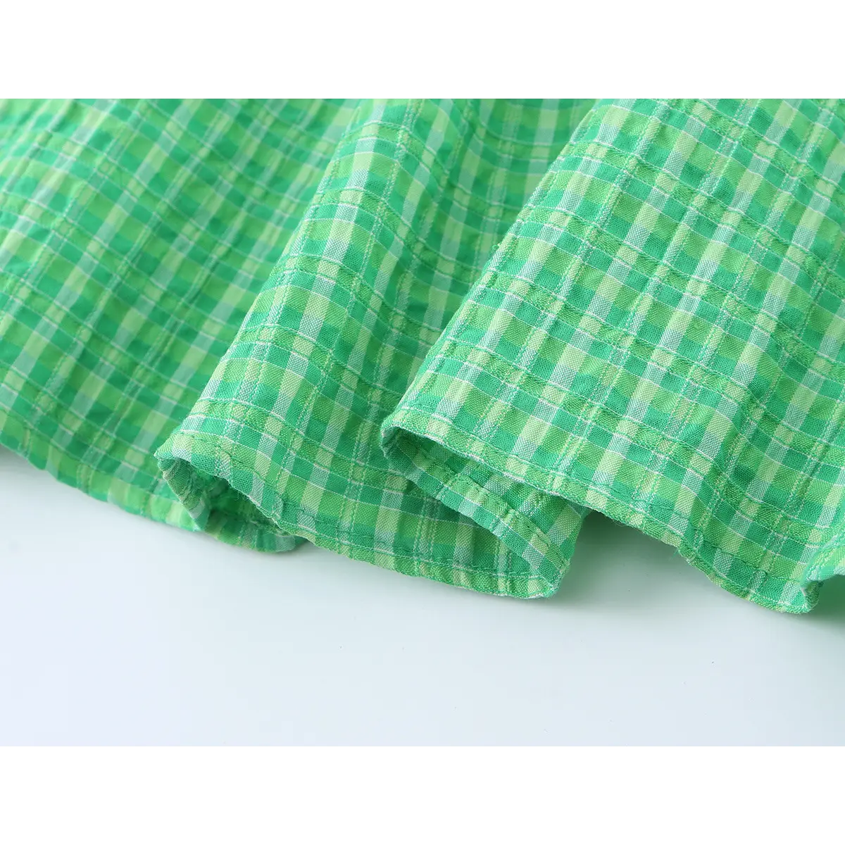 Close-up of the dress's bottom hem, showing the neat stitching and finished edge.