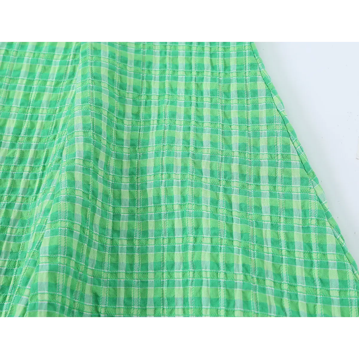 Side-angle close-up of the dress's skirt, highlighting the flared silhouette and vertical seams.
